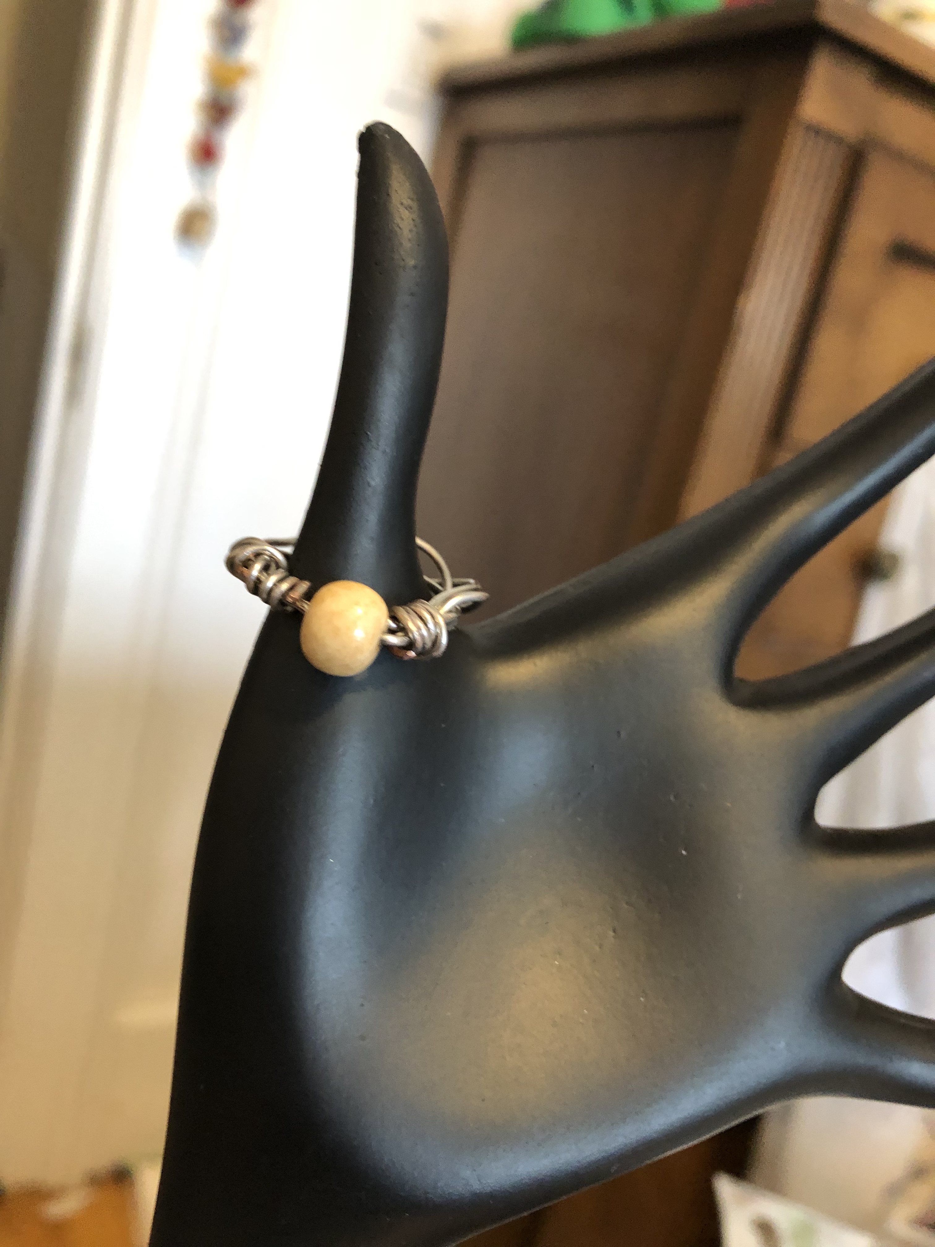 Wire-wrapped ring with bone bead at center