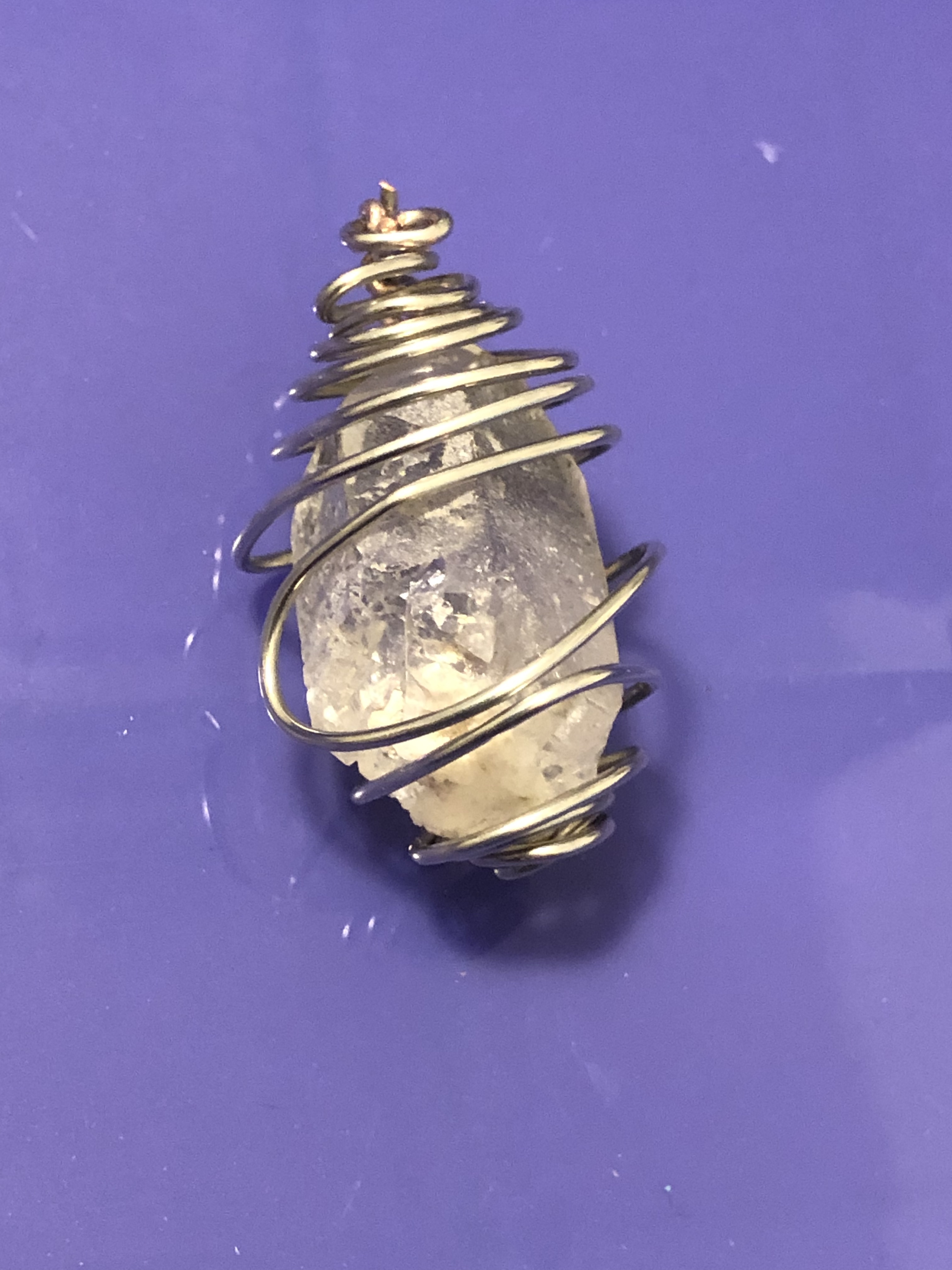 Clear quartz crystal wrapped in wire